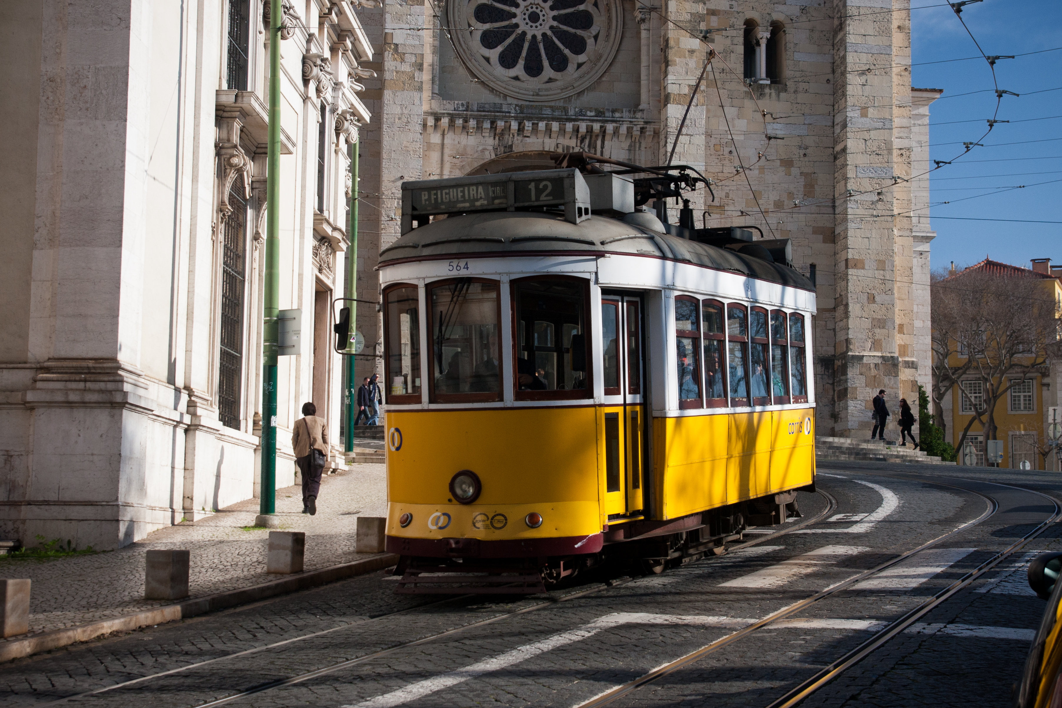 Lisbon tram passing by Lisbon Cathedral